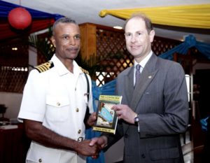 Prince Edward Earl of Wessex presented with book by Capt. Tellis A. Bethel, Commander Defence Force (Acting). Nassau, Bahamas